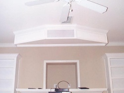 A regular TV sits in the recess above the fireplace.  For Home Theater viewing, a 100 inch motorized screen is lowered from the box on the ceiling.  The center channel speaker is also in that box.