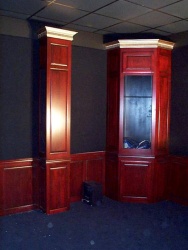 The equipment cabinet is located in the back corner of the room