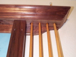 The upper holes are large enough to allow the cue to be removed without scratching or marring the finish.